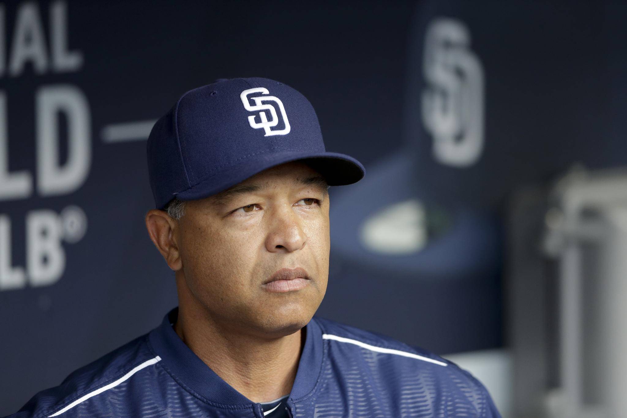 Dave Roberts, a former Dodger dons his new jersey as he is introduced as  the 10th manager of the Los Angeles Dodgers and the 28th in franchise  history, saying the post was